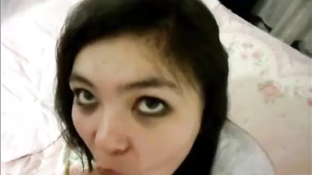 Close-up of big-eyed Asian girl getting face fucked